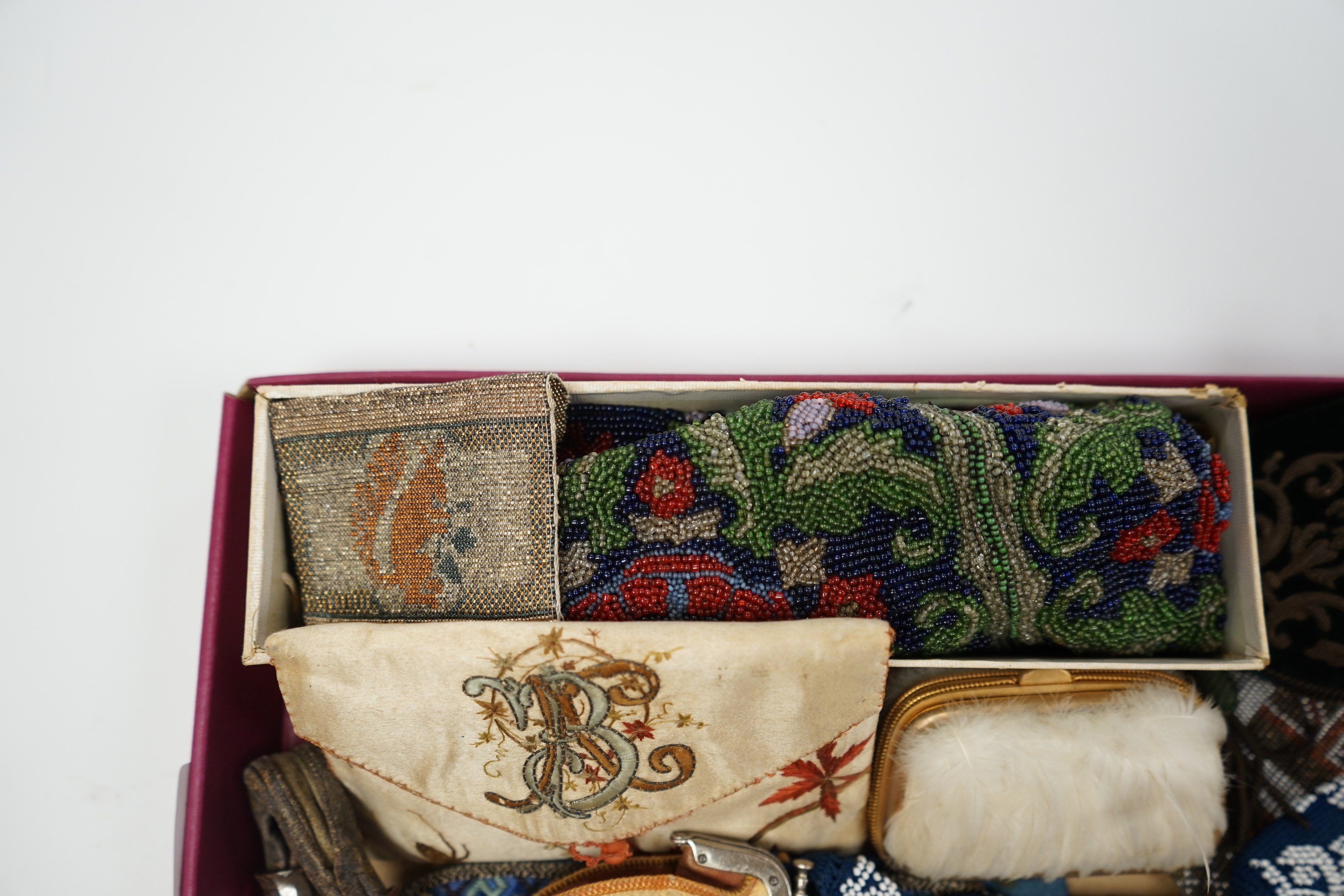 A velvet and metal embroidered reticule possibly 18th century, together with a collection of beaded embroidered knitted and leather purses, bags misers purses and a feather coin purse(14)